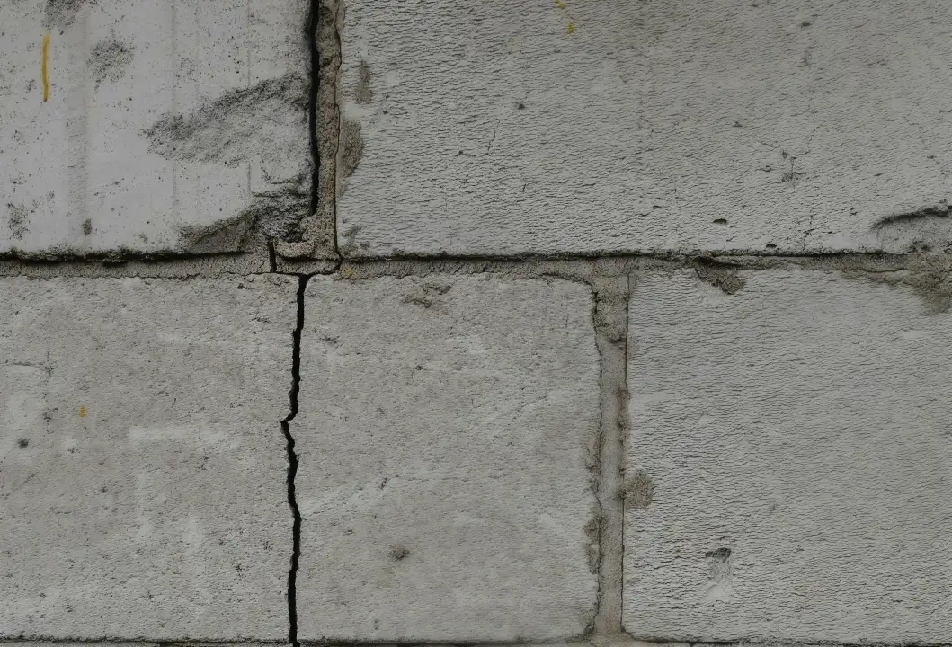 a cracked brick wall due to foundation damage
